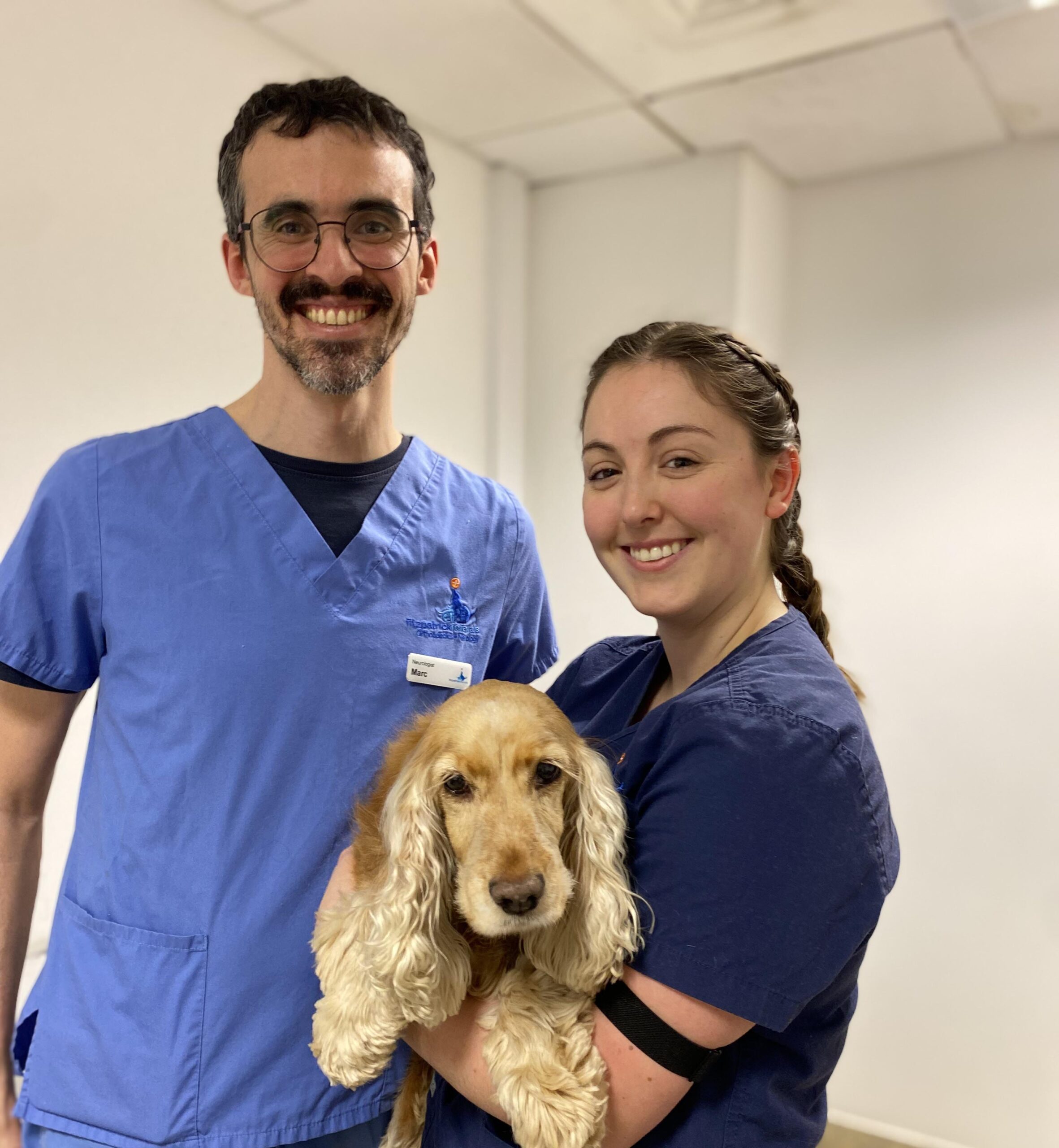Neurologist Marc Perez Soteras with nurse and cocker spaniel patient