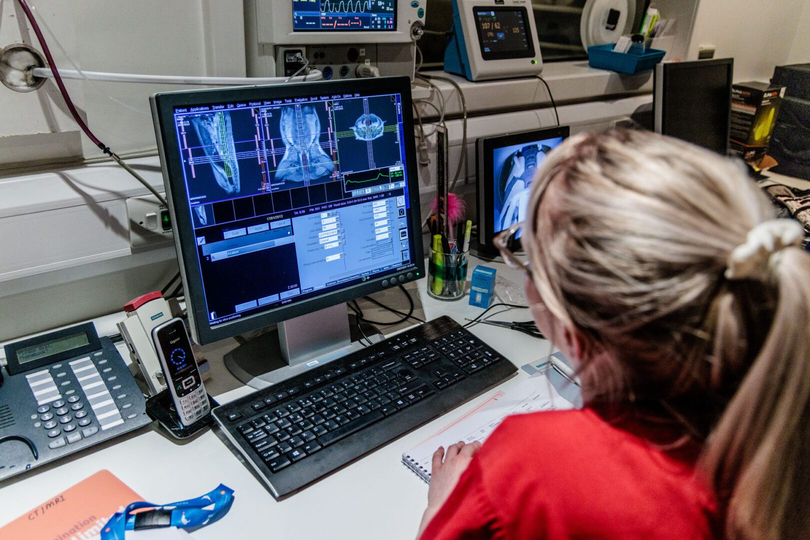 Radiographer looking at an MRI scan on a computer