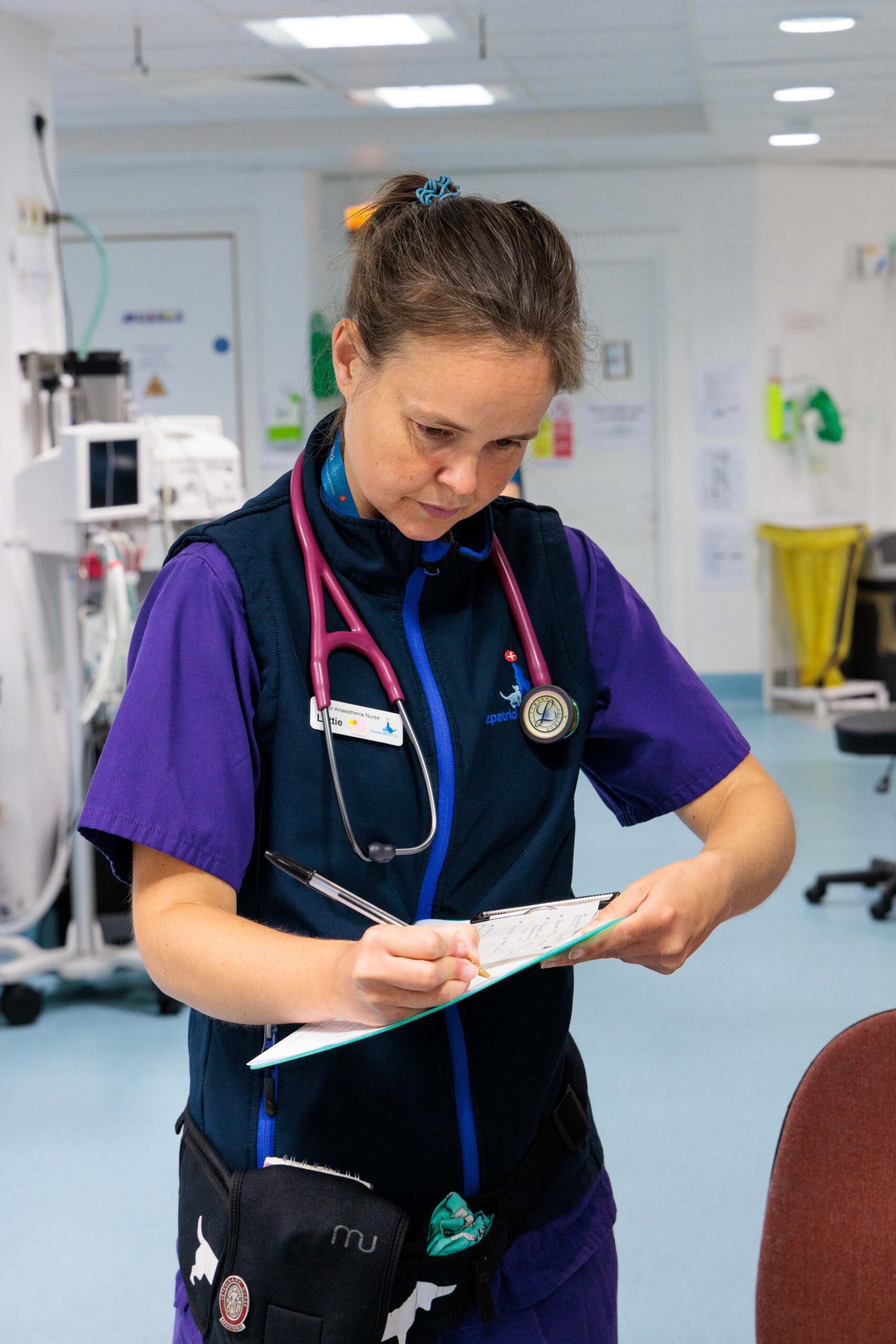 Veterinary anaesthesia nurse writing on clipboard