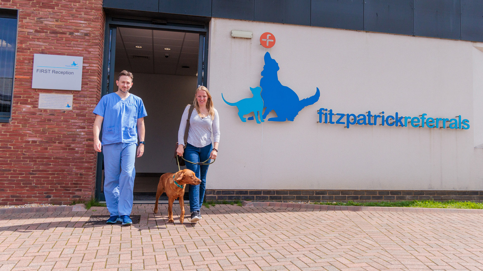 Fitzpatrick Referrals client and dog walking outside with vet specialist