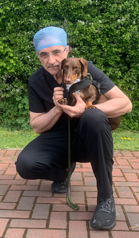 Supervet Professor Noel Fitzpatrick holding a dachshund patient