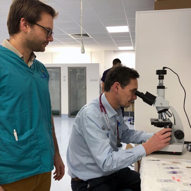 Medical Oncologist using microscope