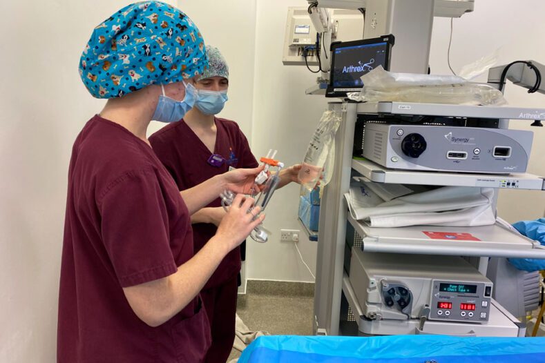 Surgical Technicians setting up the scope tower for arthroscopy